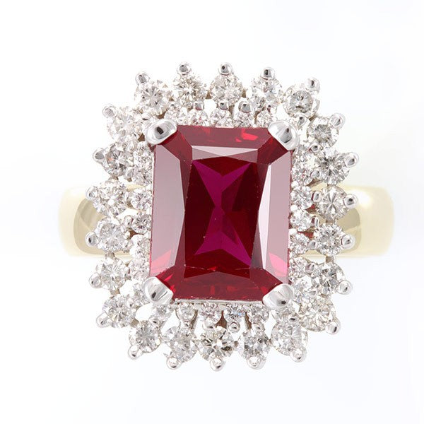 Emerald Cut Ruby Center surrounded by prong set Round Diamond in 14K Two Tone Ring